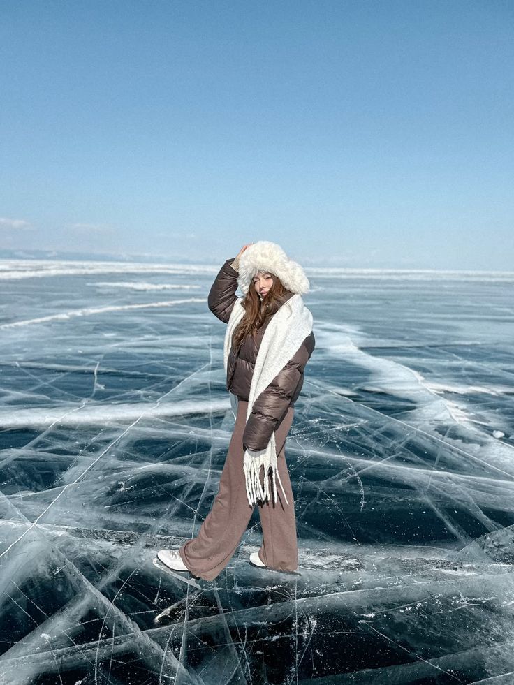 _ - 2025-12-04T131010858 Person bundled in winter clothing poses on a frozen lake under a clear blue sky, showcasing winter fashion and nature's beauty. | Sky Rye Design Person bundled in winter clothing poses on a frozen lake under a clear blue sky, showcasing winter fashion and nature's beauty.