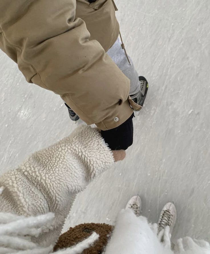 _ - 2025-12-04T132902111 Two people holding hands while ice skating, dressed warmly in jackets and gloves, enjoying a winter activity on the rink. | Sky Rye Design Two people holding hands while ice skating, dressed warmly in jackets and gloves, enjoying a winter activity on the rink.