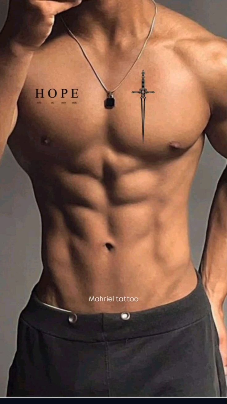 Muscular chest with HOPE text and sword tattoo, wearing a pendant necklace, showcasing fitness and artistic tattoos.