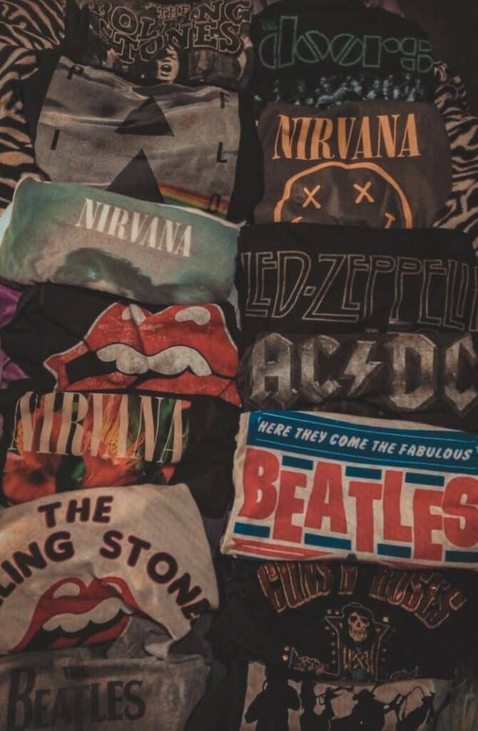 Collection of band T-shirts featuring logos of iconic rock bands like Nirvana, Led Zeppelin, and The Rolling Stones.