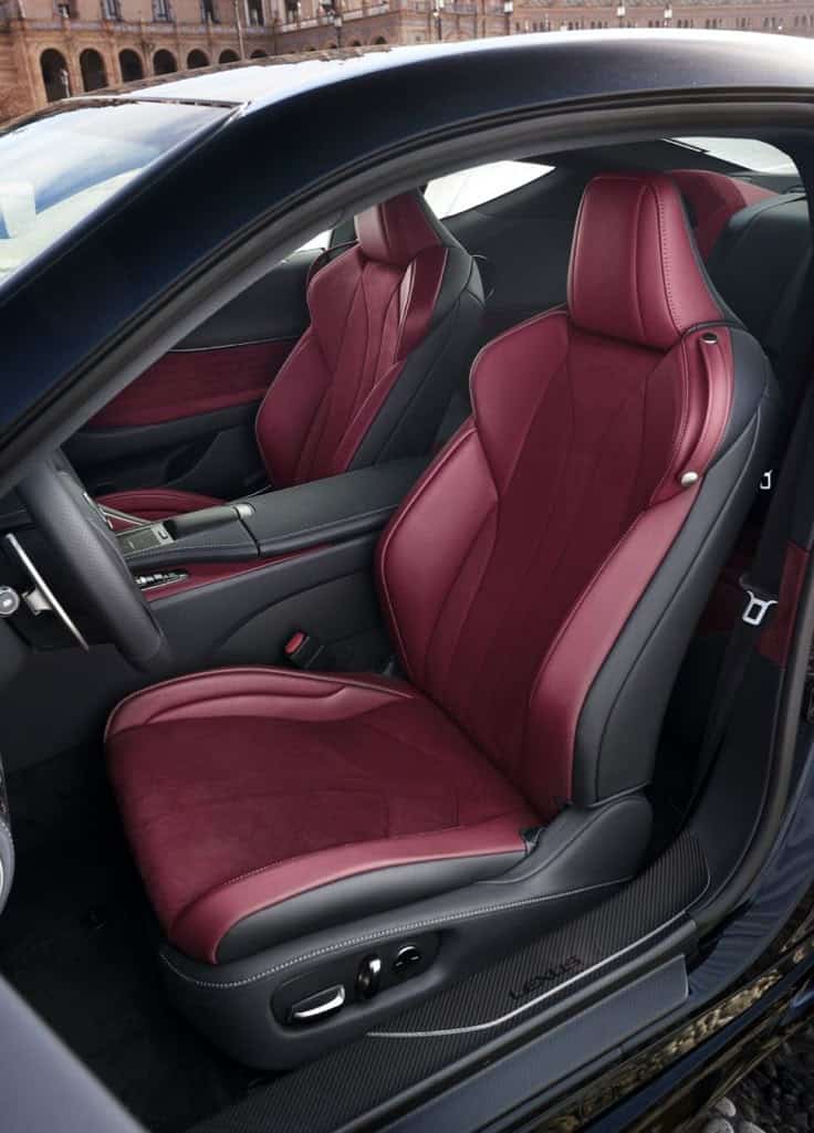 Luxury car interior with red leather seats, sleek design, and modern features, capturing elegance and comfort in automotive excellence.