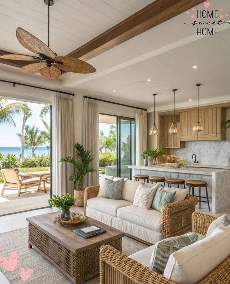 Tropical open-concept living room with ocean view, wooden accents, cozy sofas, and natural light. Text: Home Sweet Home.