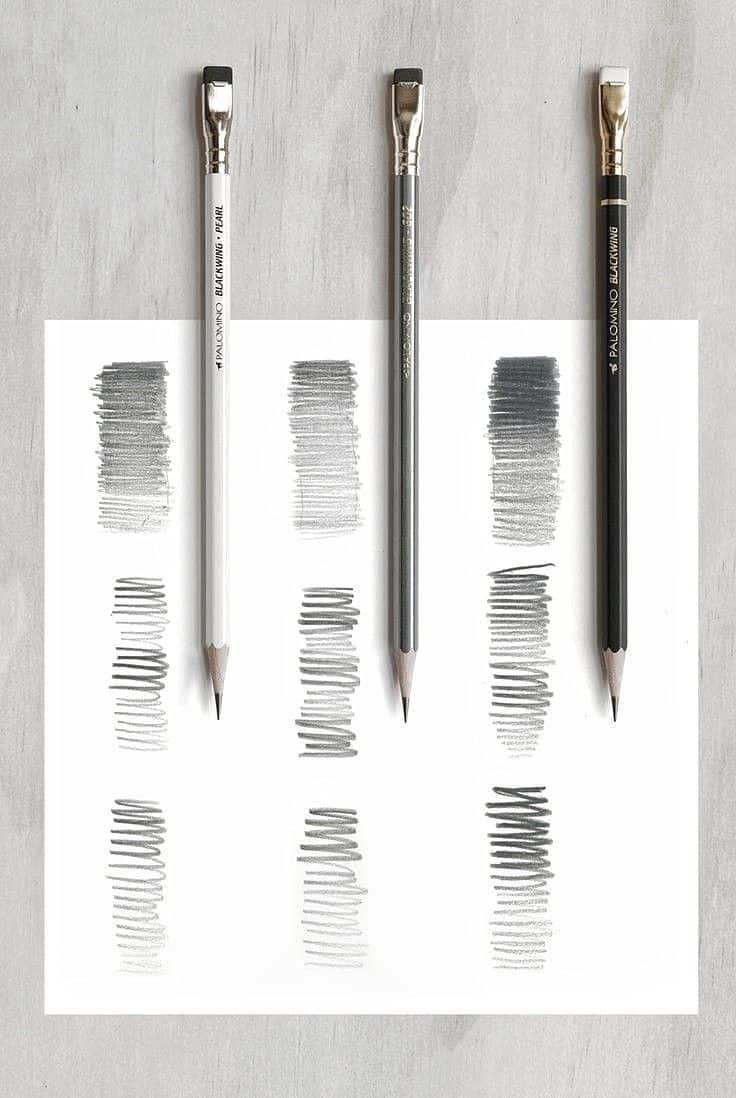 _ - 2025-12-12T005227826 Three pencils in varying shades create textured strokes on white paper, showcasing different line densities and gradients for artists. | Sky Rye Design Three pencils in varying shades create textured strokes on white paper, showcasing different line densities and gradients for artists.