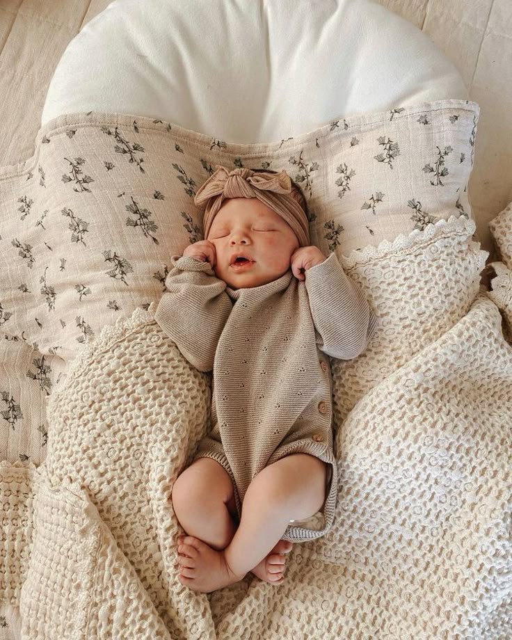 _ - 2025-12-12T131731258 Sleeping baby in a cozy beige outfit, lying on floral and crocheted blankets. Peaceful and serene nap time scene. | Sky Rye Design Sleeping baby in a cozy beige outfit, lying on floral and crocheted blankets. Peaceful and serene nap time scene.