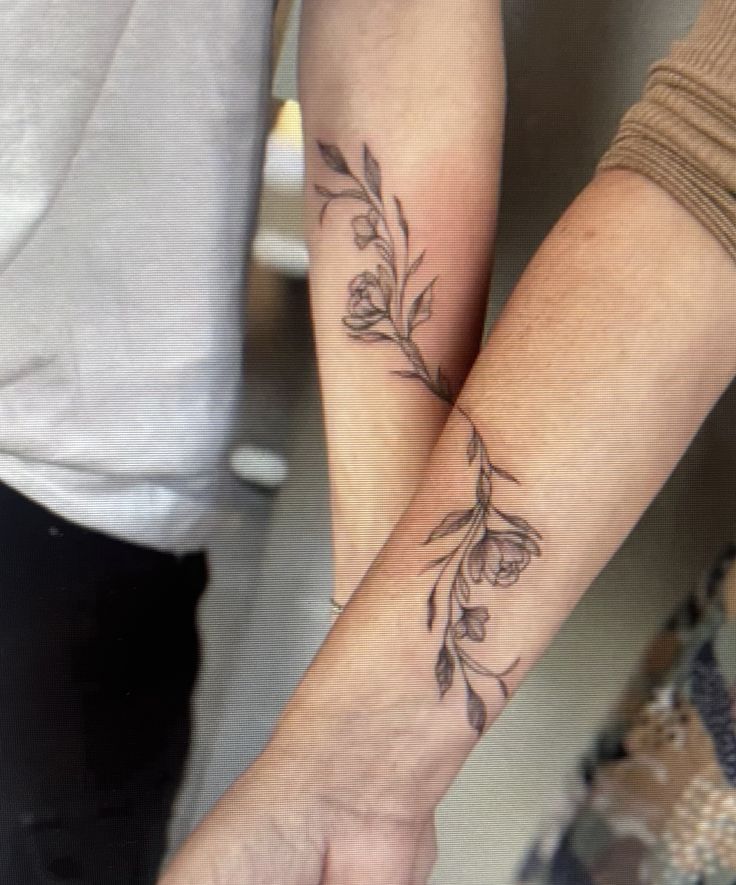 _ - 2025-12-12T144628819 Two intertwined arms showcasing elegant floral branch tattoos, symbolizing connection and growth. | Sky Rye Design Two intertwined arms showcasing elegant floral branch tattoos, symbolizing connection and growth. Daughter Mom Tattoo