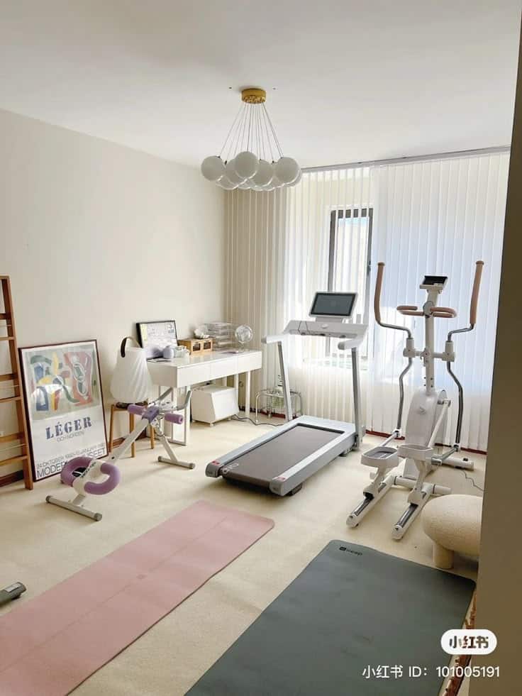 _ - 2025-12-16T183211615 Home gym with treadmill, exercise bike, and mats in a bright room with modern decor and natural light from a large window. | Sky Rye Design Home gym with treadmill, exercise bike, and mats in a bright room with modern decor and natural light from a large window.