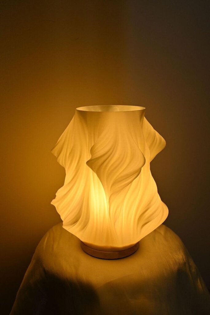 _ - 2025-12-16T234617263 Elegant sculpted lamp with soft, flowing lines casts a warm glow, creating a cozy atmosphere. Perfect for modern home decor. | Sky Rye Design Elegant sculpted lamp with soft, flowing lines casts a warm glow, creating a cozy atmosphere. Perfect for modern home decor.