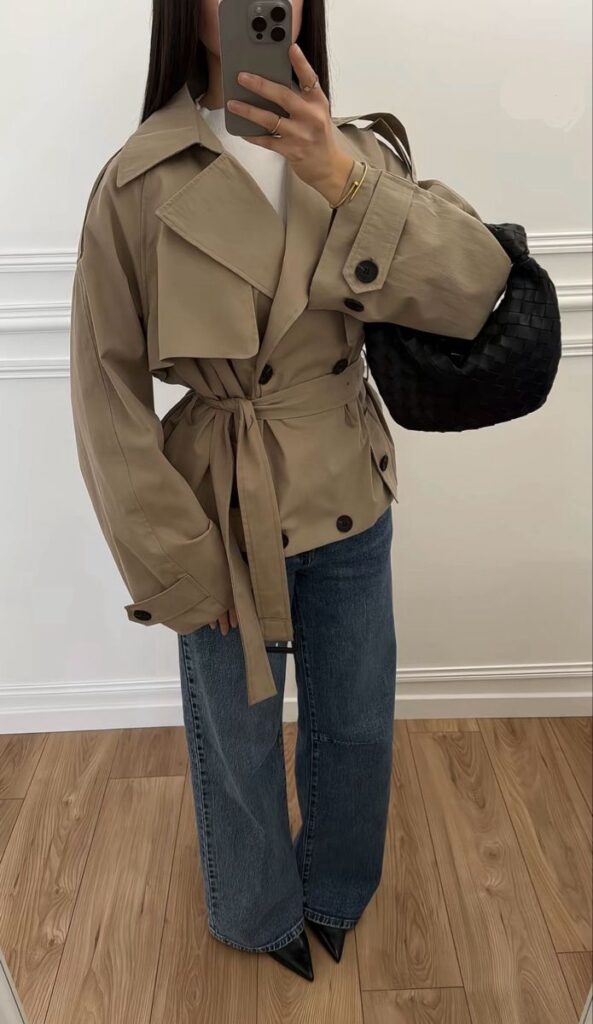 _ - 2025-12-28T121859313 Fashionable outfit featuring a beige belted trench coat, wide-leg jeans, and a black woven bag for a chic, modern look. | Sky Rye Design Fashionable outfit featuring a beige belted trench coat, wide-leg jeans, and a black woven bag for a chic, modern look.