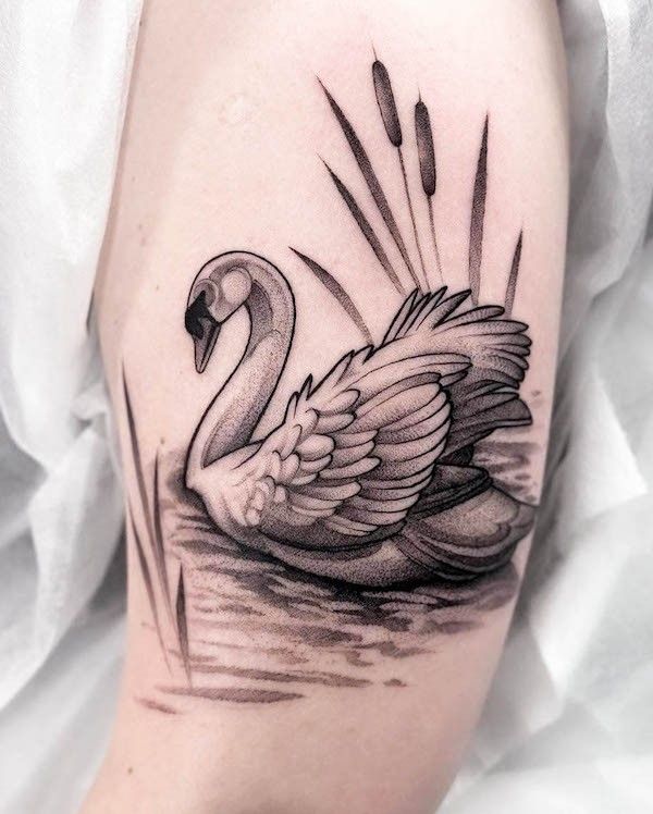 _ - 2025-12-28T162842532 Black and white tattoo of a graceful swan swimming amidst cattails on a person's arm. | Sky Rye Design Black and white tattoo of a graceful swan swimming amidst cattails on a person's arm.