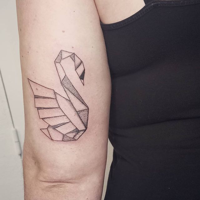 _ - 2025-12-28T163033257 Geometric origami swan tattoo on upper arm, showcasing minimalist style and artistic shading, black ink on skin. | Sky Rye Design Geometric origami swan tattoo on upper arm, showcasing minimalist style and artistic shading, black ink on skin.
