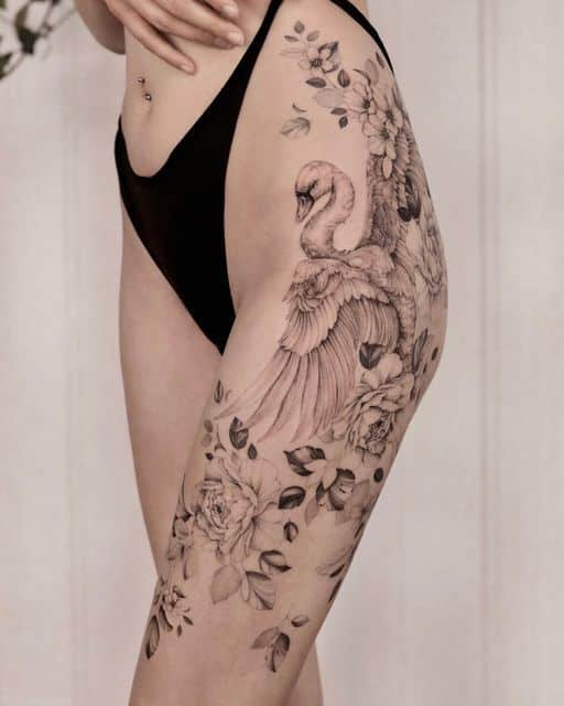 _ - 2025-12-28T164614591 Side profile of a thigh tattoo featuring a swan and floral design in black ink, showcasing intricate details and artistic elegance. | Sky Rye Design Side profile of a thigh tattoo featuring a swan and floral design in black ink, showcasing intricate details and artistic elegance.