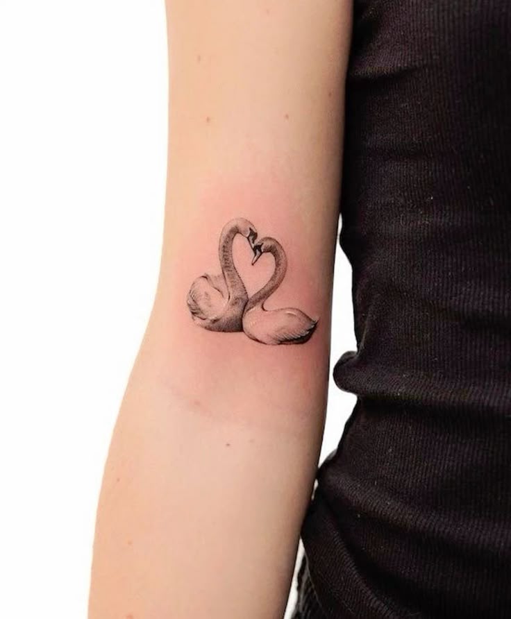 _ - 2025-12-28T164839568 Minimalist swan tattoo forming a heart shape on arm, symbolizing love and elegance. | Sky Rye Design Minimalist swan tattoo forming a heart shape on arm, symbolizing love and elegance.