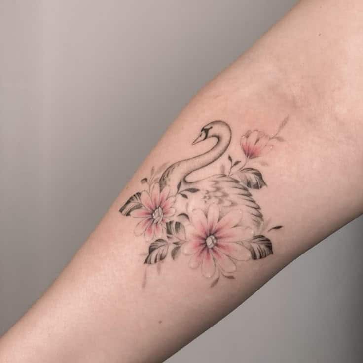 _ - 2025-12-28T164914261 Tattoo of a graceful swan with pink flowers on a forearm, showcasing soft colors and elegant design for a stylish and delicate look. | Sky Rye Design Tattoo of a graceful swan with pink flowers on a forearm, showcasing soft colors and elegant design for a stylish and delicate look.