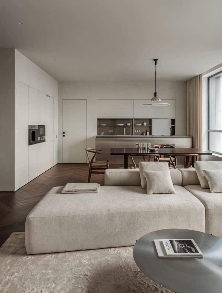 _ 22 Modern open-plan living room with beige sofa, sleek kitchen, wooden dining table, and large windows for natural light. | Sky Rye Design Modern open-plan living room with beige sofa, sleek kitchen, wooden dining table, and large windows for natural light.