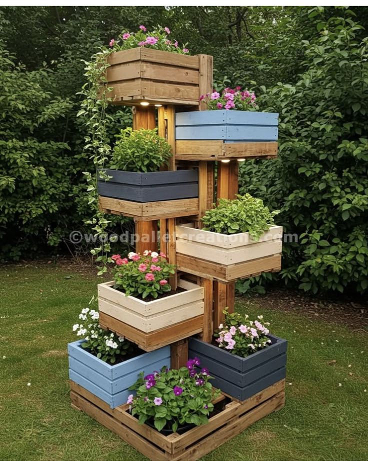 _ 23 Wooden pallet planter tower with colorful blooming flowers, set in a lush garden backdrop, showcasing vertical garden creativity. | Sky Rye Design Wooden pallet planter tower with colorful blooming flowers, set in a lush garden backdrop, showcasing vertical garden creativity.