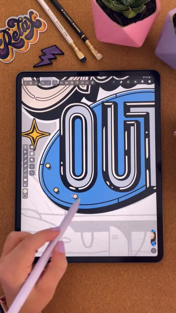 Digital illustration on a tablet with stylus, showing bold lettering and design tools. Creative workspace with pencils and stickers nearby.