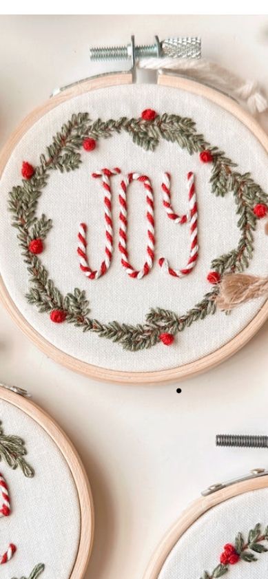 _ 29 Festive embroidery hoop art with 'Joy' central design, decorated with green and red holiday-themed garland. Perfect for Christmas decor. | Sky Rye Design Festive embroidery hoop art with 'Joy' central design, decorated with green and red holiday-themed garland. Perfect for Christmas decor.