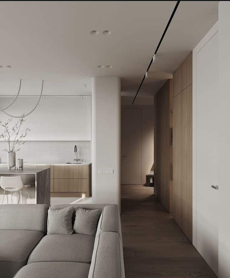 Screenshot Modern minimalist living space with a sleek kitchen, wood finishes, neutral sofa, and ambient lighting, offering a cozy atmosphere. | Sky Rye Design Modern minimalist living space with a sleek kitchen, wood finishes, neutral sofa, and ambient lighting, offering a cozy atmosphere.