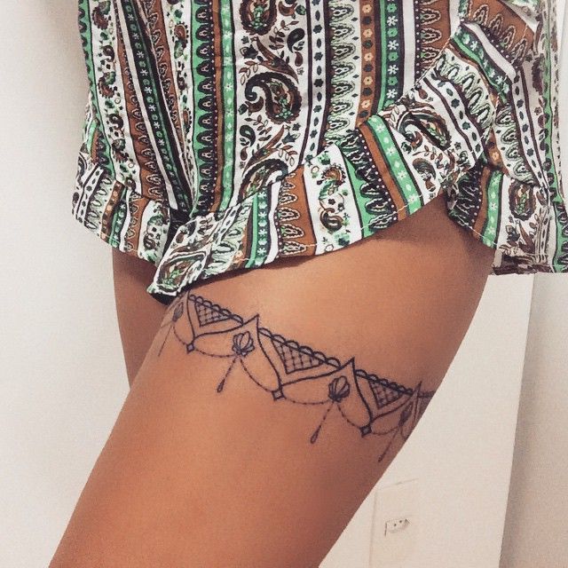 _ 3 Intricate lace-pattern thigh tattoo and colorful paisley shorts, showcasing detailed tattoo art and fashion style. | Sky Rye Design Intricate lace-pattern thigh tattoo and colorful paisley shorts, showcasing detailed tattoo art and fashion style.