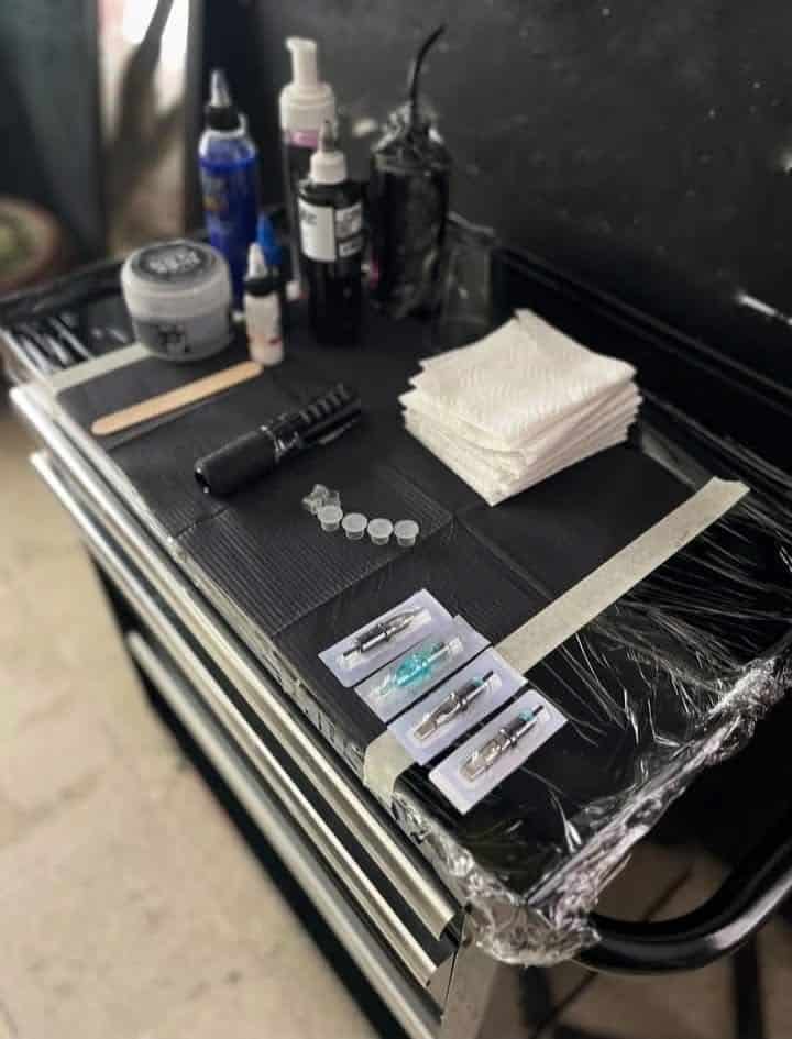 _ 3 Tattoo artist's workstation with ink, needles, and supplies neatly arranged for tattooing. | Sky Rye Design Tattoo artist's workstation with ink, needles, and supplies neatly arranged for tattooing.