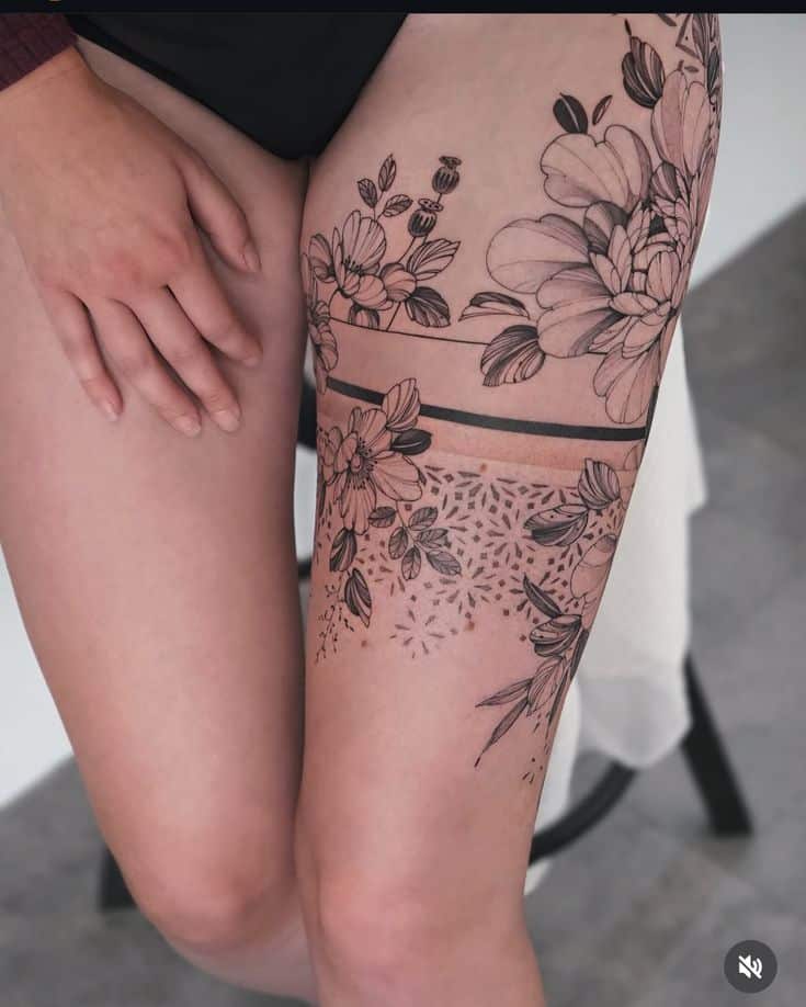 _ 30 Elegant floral thigh tattoo design in black ink, featuring intricate flower and leaf patterns, showcasing artistic detail on skin. | Sky Rye Design Elegant floral thigh tattoo design in black ink, featuring intricate flower and leaf patterns, showcasing artistic detail on skin.