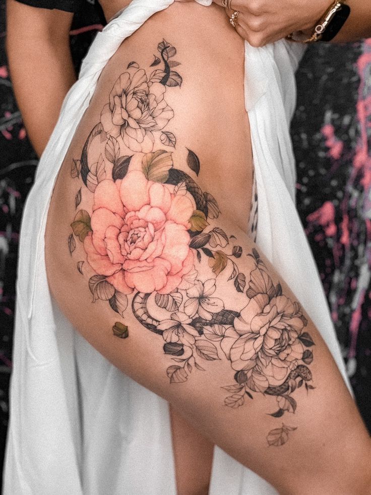 _ 32 Elegant floral thigh tattoo with intricate black and pink flower designs, draped white cloth, and detailed leaves. | Sky Rye Design Elegant floral thigh tattoo with intricate black and pink flower designs, draped white cloth, and detailed leaves.