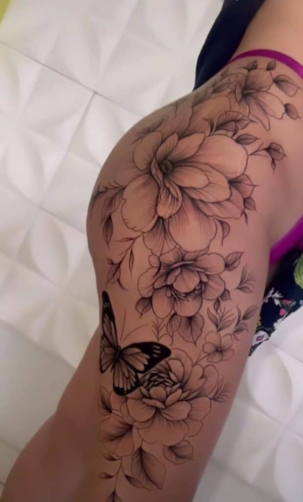 _ 36 Intricate floral and butterfly tattoo design on upper leg, showcasing detailed artistry and elegant lines on smooth skin. | Sky Rye Design Intricate floral and butterfly tattoo design on upper leg, showcasing detailed artistry and elegant lines on smooth skin. floral thigh tattoos for women