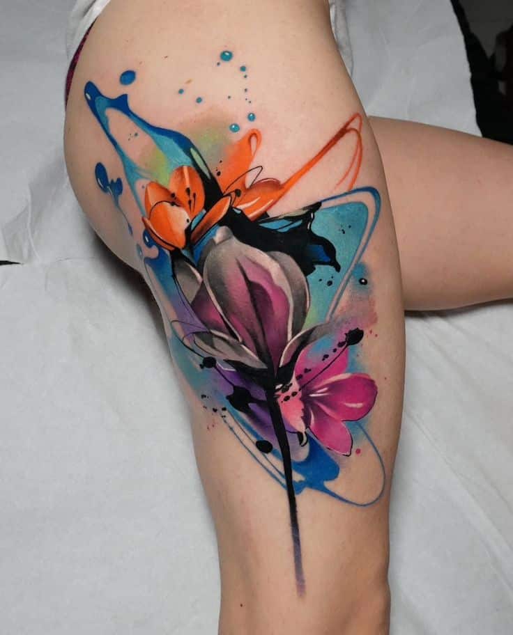 _ 4 Vibrant watercolor floral tattoo on thigh, featuring colorful petals and abstract splashes in blue, pink, and orange hues. | Sky Rye Design Vibrant watercolor floral tattoo on thigh, featuring colorful petals and abstract splashes in blue, pink, and orange hues.