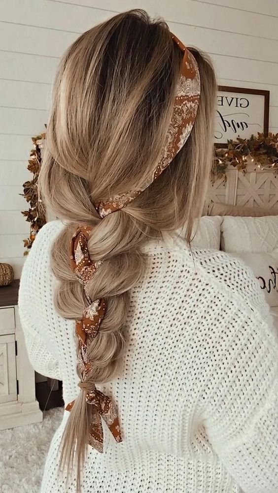 _ 41 Blonde hair in a stylish braid adorned with a brown floral scarf, worn by a woman in a cozy white sweater. | Sky Rye Design Blonde hair in a stylish braid adorned with a brown floral scarf, worn by a woman in a cozy white sweater.
