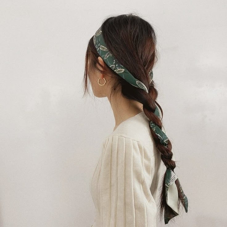 _ 42 Woman with braided hair and green patterned headscarf, wearing a cream top, showcasing a casual chic hairstyle from a side view. | Sky Rye Design Woman with braided hair and green patterned headscarf, wearing a cream top, showcasing a casual chic hairstyle from a side view.
