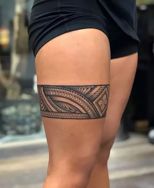 43 Traditional Polynesian Tattoo Designs With Meanings Geometric tribal thigh tattoo with intricate patterns on a person wearing black shorts, showcasing bold design and artistic detail. | Sky Rye Design Geometric tribal thigh tattoo with intricate patterns on a person wearing black shorts, showcasing bold design and artistic detail.