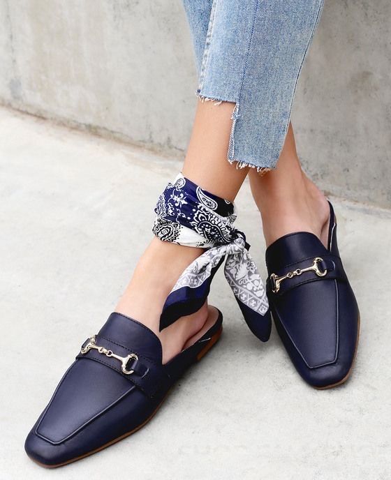 _ 48 Stylish navy loafers with gold accents paired with blue jeans and a patterned bandana around the ankle on a concrete background. | Sky Rye Design Stylish navy loafers with gold accents paired with blue jeans and a patterned bandana around the ankle on a concrete background.