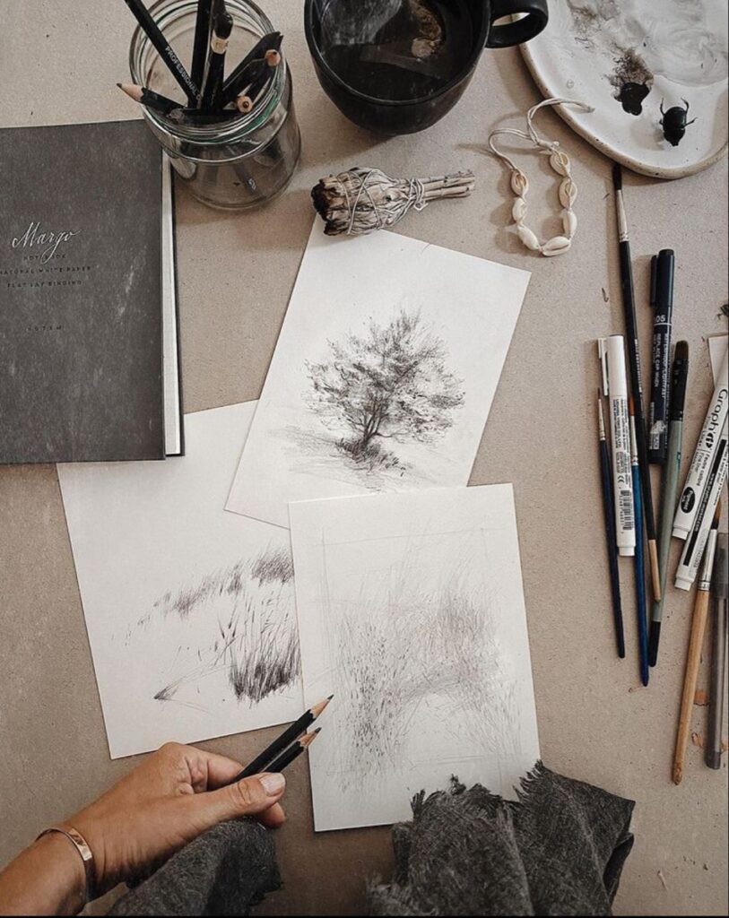 4cd73e9a8744e516431c8e79ec5fa086 Artistic workspace featuring sketches, pencils, and painting supplies, evoking creativity and inspiration in a cozy, rustic setting. | Sky Rye Design Artistic workspace featuring sketches, pencils, and painting supplies, evoking creativity and inspiration in a cozy, rustic setting.