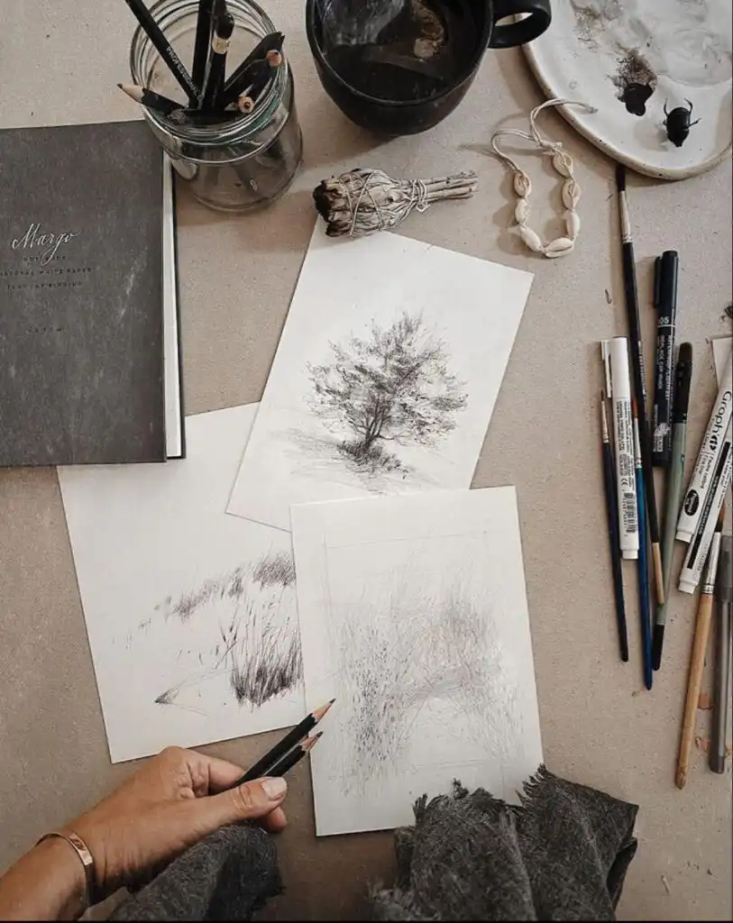 4cd73e9a8744e516431c8e79ec5fa086 Artistic workspace featuring sketches, pencils, and painting supplies, evoking creativity and inspiration in a cozy, rustic setting. | Sky Rye Design Artistic workspace featuring sketches, pencils, and painting supplies, evoking creativity and inspiration in a cozy, rustic setting.