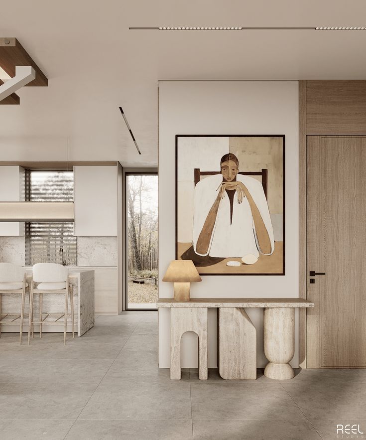 Modern minimalist kitchen with a unique abstract painting, neutral tones, and stylish stone console table with decorative lamp.