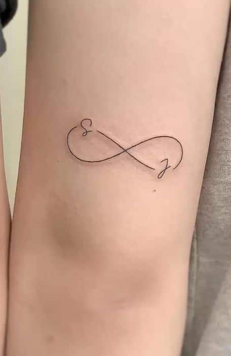 50 Best Infinity Tattoo Designs Meaning Minimal infinity tattoo with initials S and J on a person's skin. Simple, elegant design representing endless connection. | Sky Rye Design Minimal infinity tattoo with initials S and J on a person's skin. Simple, elegant design representing endless connection.
