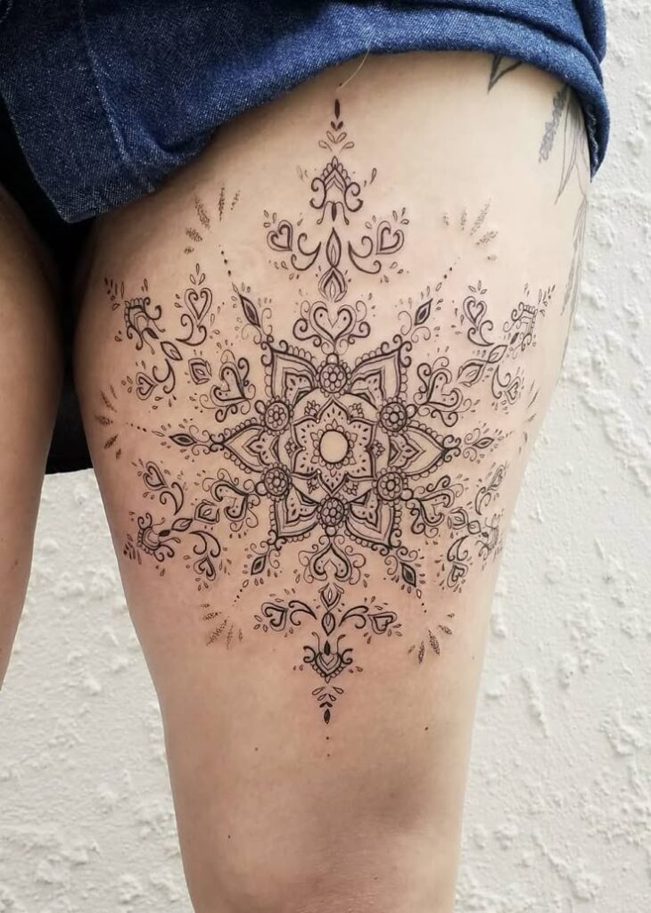 50 of the Most Beautiful Mandala Tattoo Designs for Your Body Soul Intricate mandala thigh tattoo featuring geometric and floral patterns, showcasing detailed artistry on light skin under denim shorts. | Sky Rye Design Intricate mandala thigh tattoo featuring geometric and floral patterns, showcasing detailed artistry on light skin under denim shorts.