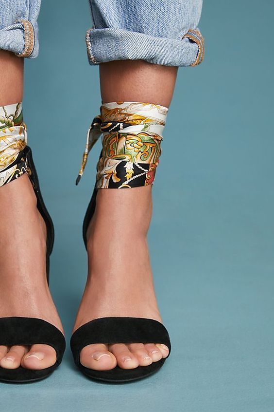 _ 50 Fashionable ankles with patterned scarf bracelets, paired with rolled-up jeans and black open-toe heels, on a teal background. | Sky Rye Design Fashionable ankles with patterned scarf bracelets, paired with rolled-up jeans and black open-toe heels, on a teal background.