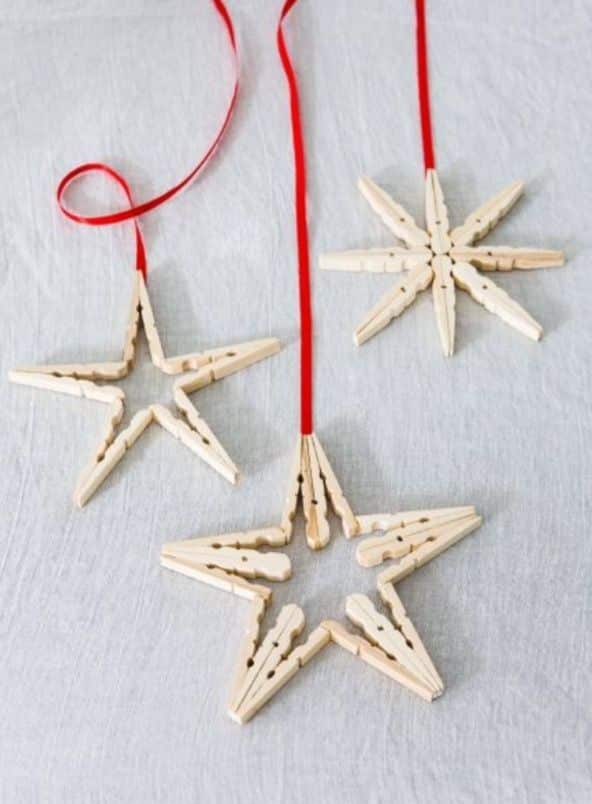 55cf8217b19bfa231ce277bbd6bc5cd3 DIY star ornaments made from clothespins with red ribbon hang on a light background. Perfect for holiday decorations and crafts. | Sky Rye Design DIY star ornaments made from clothespins with red ribbon hang on a light background. Perfect for holiday decorations and crafts.