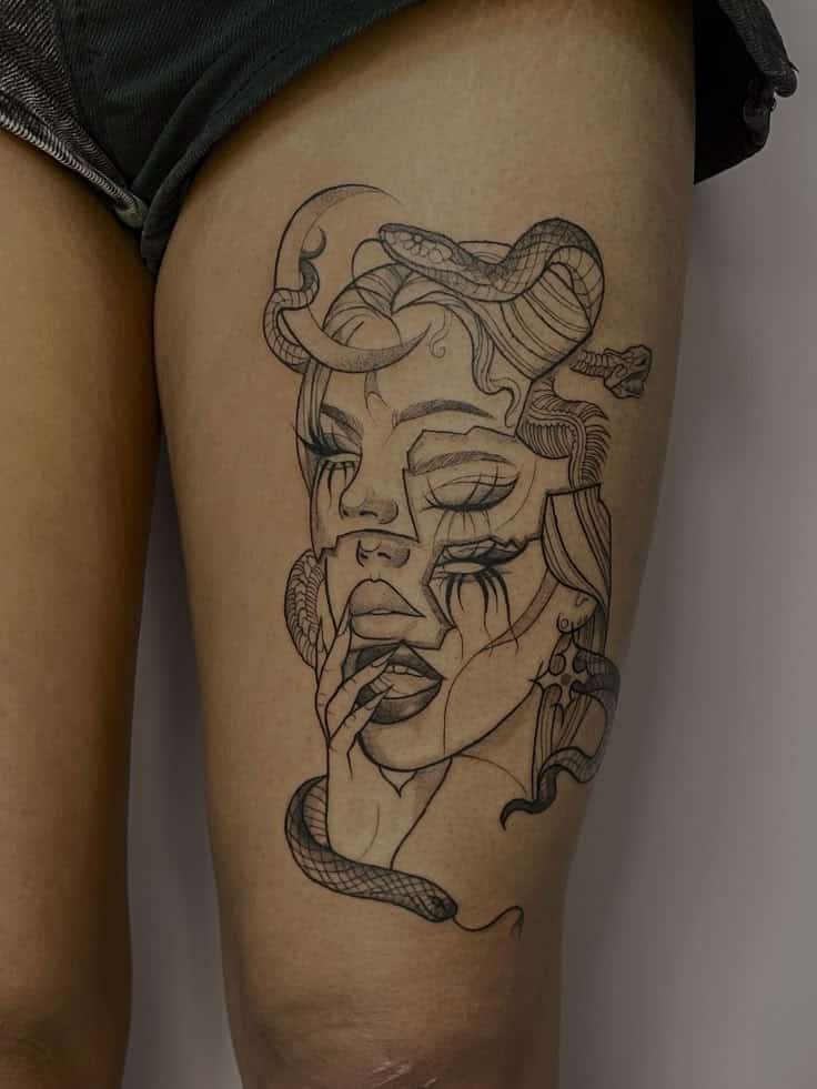 56 Best Thigh Tattoos for Women_ Feminine Fierce and Fearlessly Flawless Abstract face tattoo with snake design on upper thigh, showcasing intricate linework and surreal elements for modern body art inspiration. | Sky Rye Design Abstract face tattoo with snake design on upper thigh, showcasing intricate linework and surreal elements for modern body art inspiration.