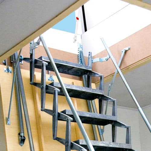Attic foldable ladder extended, featuring a metal frame and wooden accents, leading up to a bright blue sky through an open ceiling hatch.