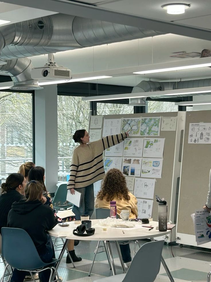 _ 6 Group collaborating in a modern office, discussing design sketches on a board during a creative meeting. | Sky Rye Design Group collaborating in a modern office, discussing design sketches on a board during a creative meeting.