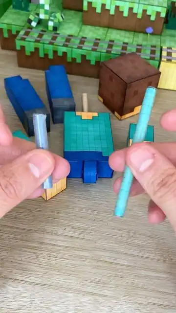 _ 6 Crafting a paper figure with colored components, featuring a Minecraft-inspired design on a wooden table. | Sky Rye Design Crafting a paper figure with colored components, featuring a Minecraft-inspired design on a wooden table.
