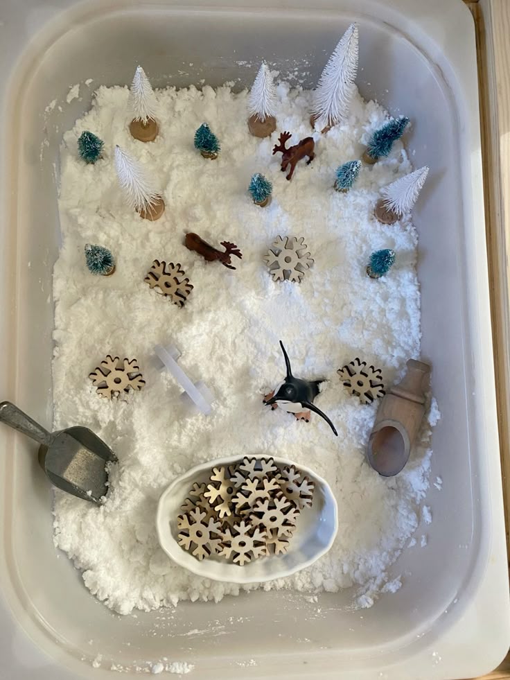 64bf70e84b0fdccc3b972e998e8edef6 Winter sensory bin with artificial snow, miniature trees, animals, and wooden snowflakes. Perfect for a festive or educational activity. | Sky Rye Design Winter sensory bin with artificial snow, miniature trees, animals, and wooden snowflakes. Perfect for a festive or educational activity.