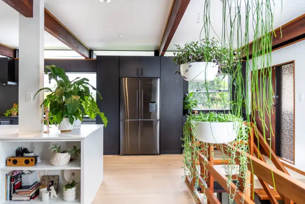 6853773531b351125a7a2a31_656e6eeab3d5742dfdeeb1e0_2021-01-20-Maintain-to-Profit-135-Eban-Ave-12 Modern kitchen with plants, sleek stainless steel fridge, white cabinetry, and hanging planters create a fresh, inviting space. | Sky Rye Design Modern kitchen with plants, sleek stainless steel fridge, white cabinetry, and hanging planters create a fresh, inviting space.