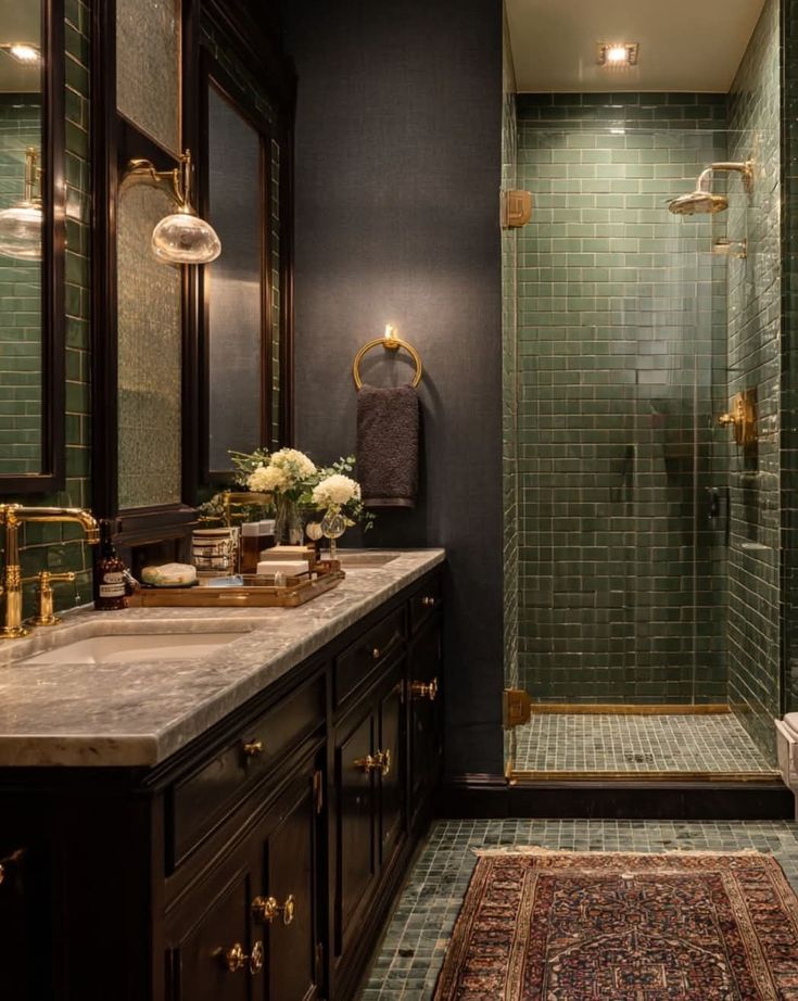 _ 72 Luxurious bathroom with green tiled shower, elegant dark wood vanity, marble countertop, brass fixtures, and soft ambient lighting. | Sky Rye Design Luxurious bathroom with green tiled shower, elegant dark wood vanity, marble countertop, brass fixtures, and soft ambient lighting.