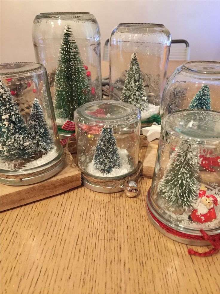 758e973890e00158d23eb2783847a8ae DIY snow globes made from jars featuring miniature Christmas trees and snow on a wooden table. Perfect for festive decor or craft ideas. | Sky Rye Design DIY snow globes made from jars featuring miniature Christmas trees and snow on a wooden table. Perfect for festive decor or craft ideas.