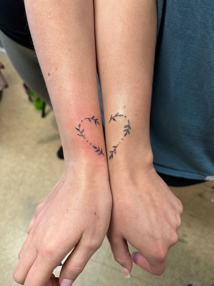 78 Minimalist Tattoos That Will Inspire You To Get Inked Minimalist half-heart leaf tattoos on two inner wrists, symbolizing connection and unity. Perfect inspiration for matching tattoo ideas. | Sky Rye Design Minimalist half-heart leaf tattoos on two inner wrists, symbolizing connection and unity. Perfect inspiration for matching tattoo ideas.