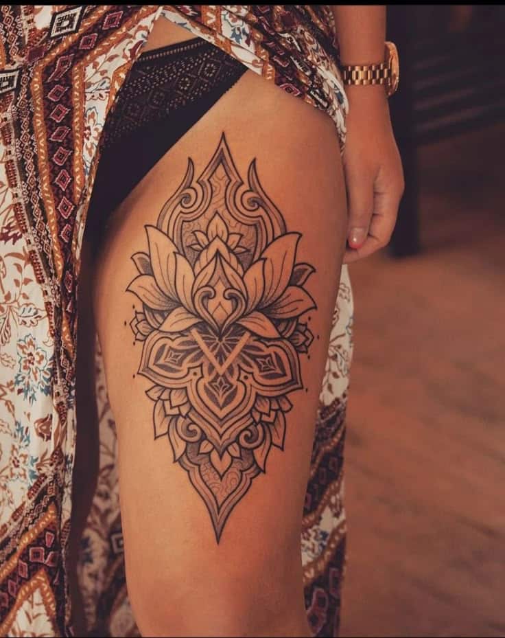 _ 8 Elegant and intricate thigh tattoo design featuring floral and geometric patterns, showcased on a person wearing a patterned dress. | Sky Rye Design Elegant and intricate thigh tattoo design featuring floral and geometric patterns, showcased on a person wearing a patterned dress.