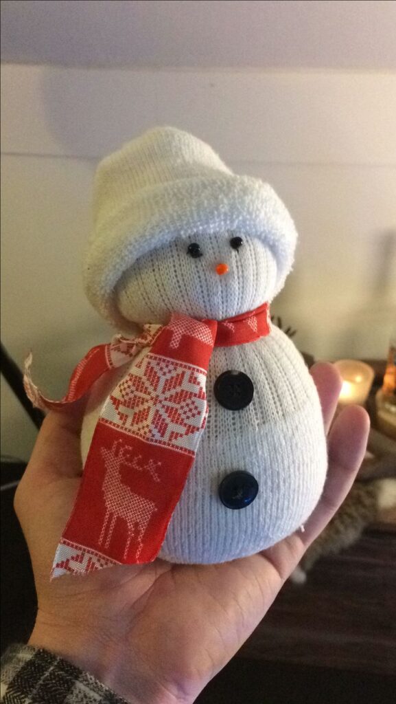 8a0efc7d32ed46f59e11c1f68e4fa361 Hand holding a cute DIY sock snowman with red scarf and buttons, perfect for Christmas decoration or craft ideas. | Sky Rye Design Hand holding a cute DIY sock snowman with red scarf and buttons, perfect for Christmas decoration or craft ideas.